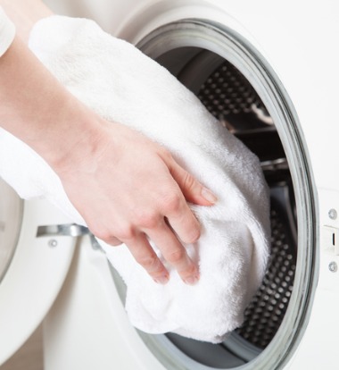 Hands Loading Commercial Washer and Dryer in Bloomington IL